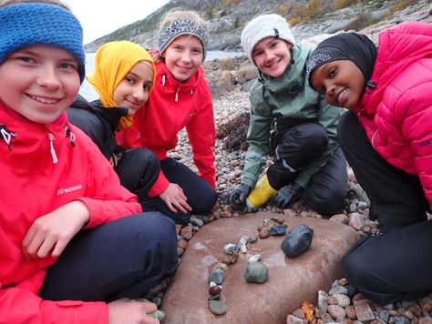 Elever som har samlet steiner på stranda